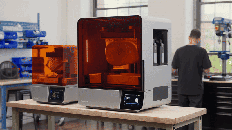 A Formlabs Form 4 and Form 4L side by side showing the difference in build platform size